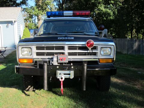 1987 Dodge 1500 - This Dodge pickup truck features a winch and emergency lights on its front end.