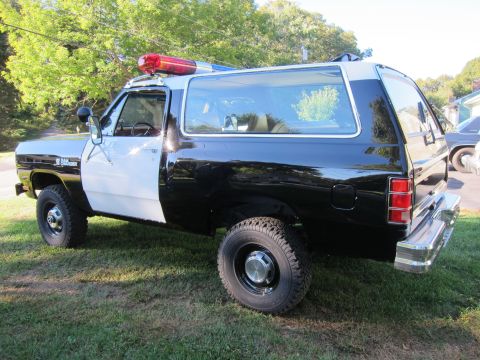 1987 Dodge 1500 - Side view of a 1987 Dodge Ramcharger modified as a police vehicle with a light bar.