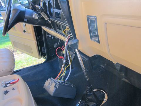 1987 Dodge 1500 - The dashboard and center console of a vehicle are visible, with wires and electronic components exposed for repair or modification.
