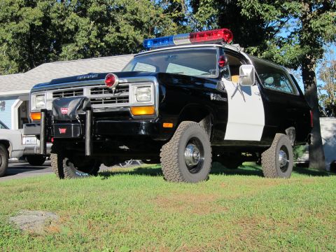 1987 Dodge 1500 - This police SUV, likely from the 1980s, features a distinctive grille and body style.