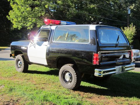 1987 Dodge 1500 - This 1987 Dodge 1500 police SUV features a classic black and white paint scheme and a light bar on the roof.