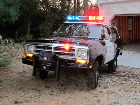 1987 Dodge 1500 - This Dodge Ramcharger-based police vehicle features a light bar and a front-mounted winch, suggesting it is equipped for off-road or heavy-…