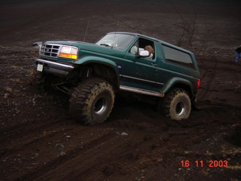 1996 Ford Bronco - This 1996 Ford Bronco is shown off-roading on a muddy, uneven terrain.