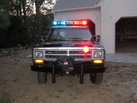 1987 Dodge 1500 - This 1987 Dodge pickup truck is equipped with emergency lights and a winch, suggesting it may be a former emergency vehicle.