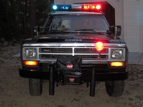 1987 Dodge 1500 - Front view of a 1987 Dodge 1500 police truck equipped with a light bar and a Warn winch.