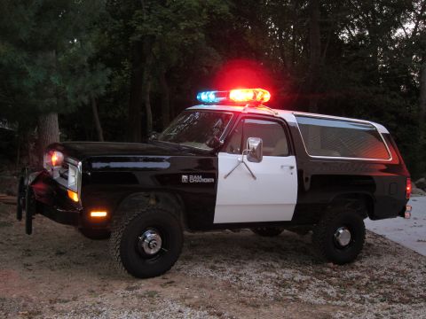 1987 Dodge 1500 - This 1987 Dodge Ramcharger is outfitted as a police vehicle, a black and white paint scheme and a light bar on the roof.