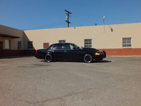 2003 Ford Crown Victoria - Lowered Crown Vic shown in profile across an empty industrial lot.