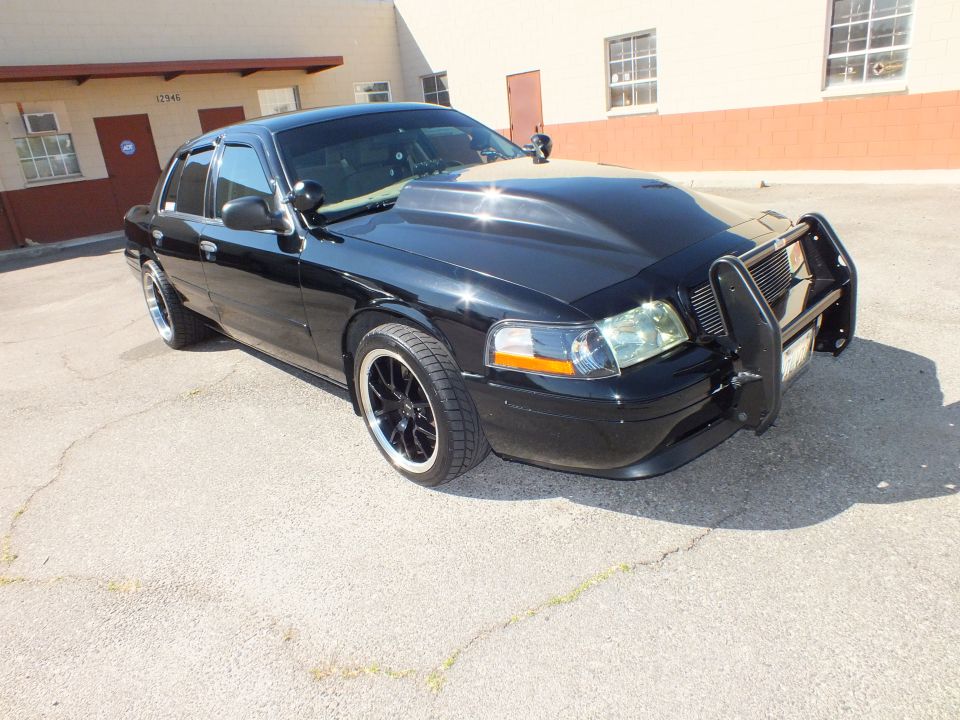 Black Crown Victoria front quarter with push bar, lowered on black machined wheels