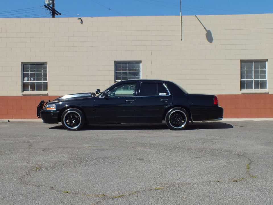 Black Crown Victoria Police Interceptor full side profile with push bar lowered stance
