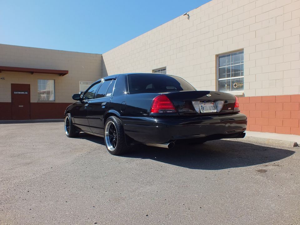 Black Crown Victoria rear quarter with Ford oval and SVT badge on trunk