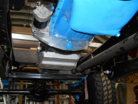 1992 Ford Bronco - Underside view of a vehicle's engine bay, highlighting a blue engine component and starter motor. The Supermotors.net logo is present in th…
