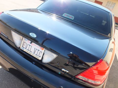 2003 Ford Crown Victoria - Trunk closeup showing Ford oval, SVT badge and California EVIL VIC Crown Victoria plate.