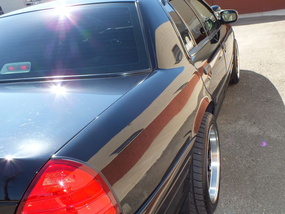 Black Crown Victoria rear quarter panel closeup with taillight and rear wheel