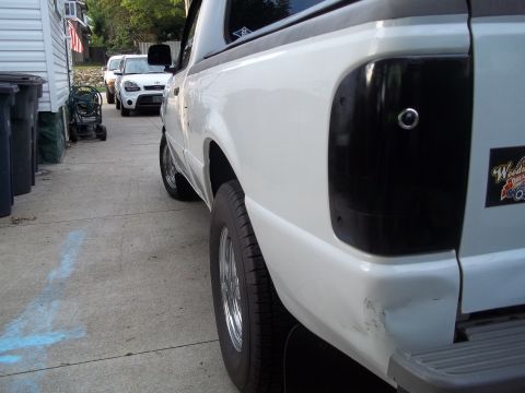 1970 Ford Ranchero - A white pickup truck is parked in a driveway next to a white Kia Soul.
