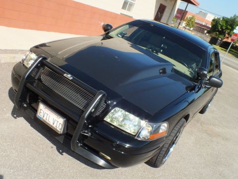 2003 Ford Crown Victoria - High-angle front three-quarter of a black Crown Victoria with push bumper, billet grille and EVIL VIC plate