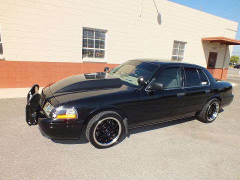 2003 Ford Crown Victoria - Driver-side profile of a black Crown Victoria sedan lowered on black wheels with whitewall tires