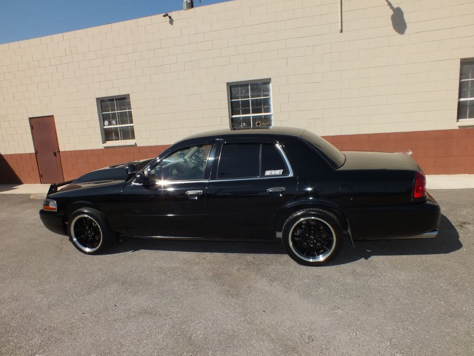 Black Mercury Grand Marquis passenger side profile lowered on black wheels
