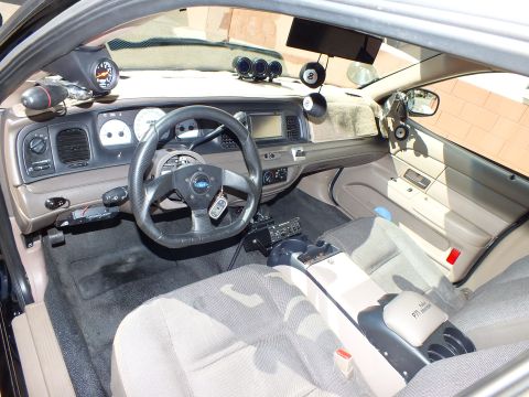 2003 Ford Crown Victoria - Interior view showing dash-mounted touchscreen, custom steering wheel, floor shifter and overhead gauges