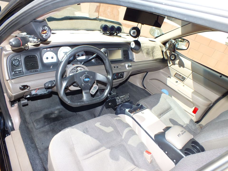 Custom sedan interior with touchscreen head unit, small steering wheel and gauge pods