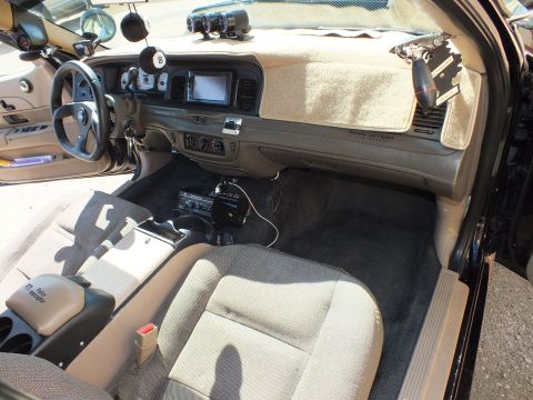 2003 Ford Crown Victoria - Cabin shot showing dash-mounted touchscreen, floor shifter, custom wheel and carpet-covered dashboard