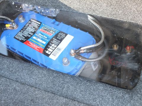 2003 Ford Crown Victoria - Optima Blue Top battery secured in a carpeted trunk compartment with heavy power cabling and terminals