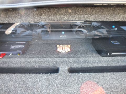 2003 Ford Crown Victoria - Trunk amp rack with twin Alpine amps, a Soundstream Epicenter and a Transformers Autobot badge centered