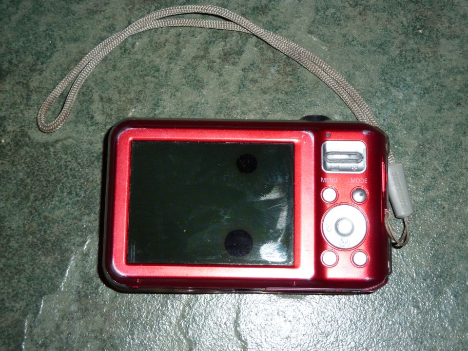 Red digital camera with strap and buttons