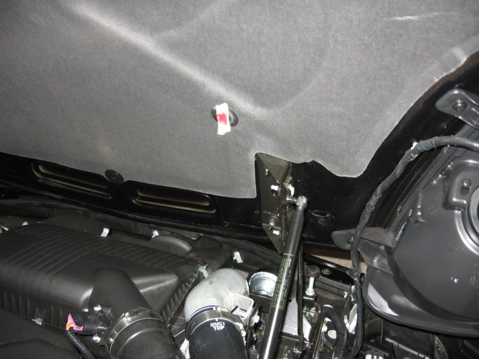 under hood shot of engine components and hood insulation