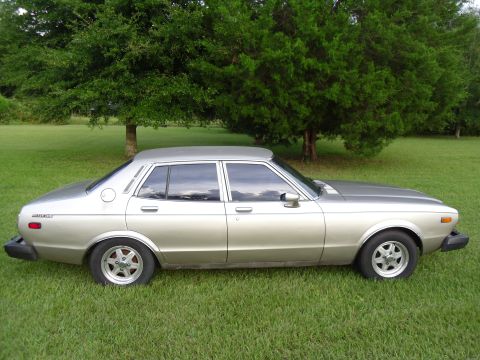 1978 Nissan Maxima - This sedan has a boxy shape and chrome trim, typical of cars from the late 1970s.