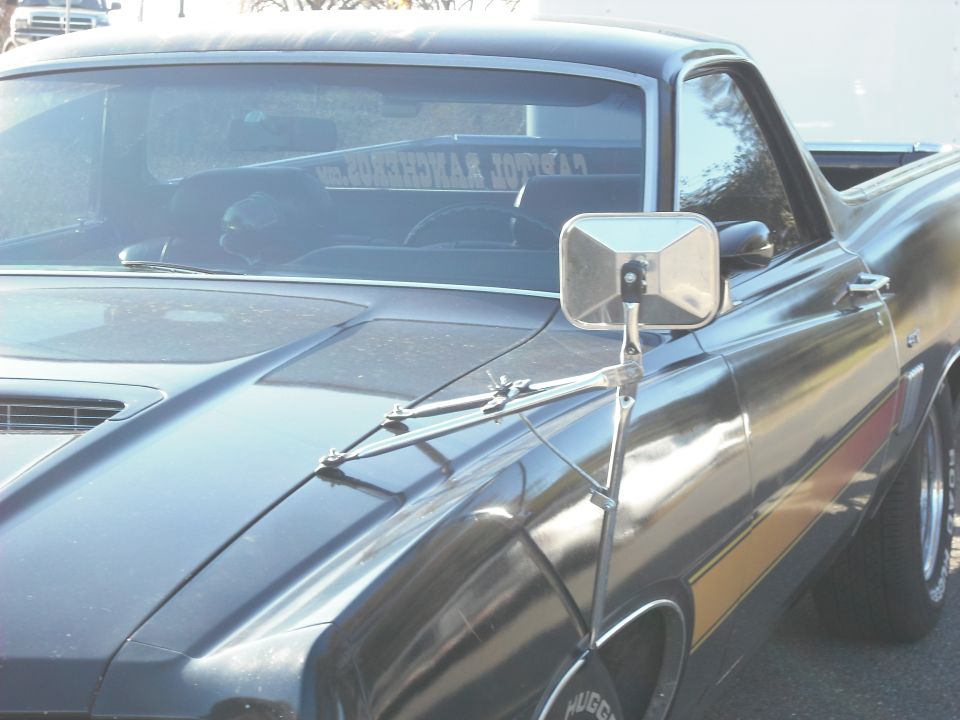 Black 1970 Ford Ranchero with side stripe and fender mirror