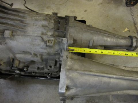 1971 Ford Ranchero - A close-up view of a transmission part with a measuring tape indicating its dimensions.