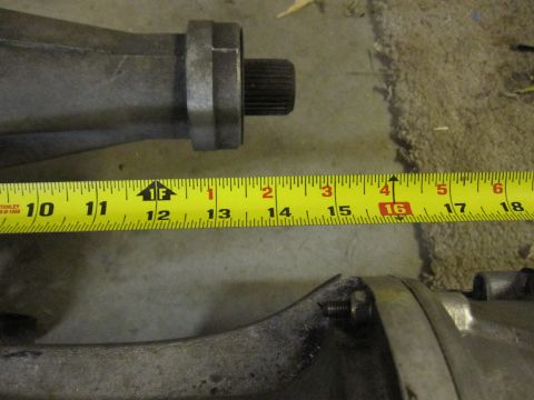 1971 Ford Ranchero - A measuring tape is placed against a metal automotive differential housing, indicating a length of about 16 inches.