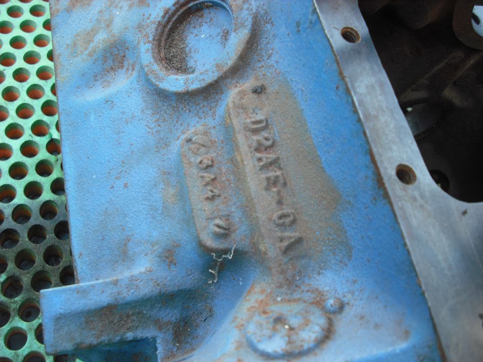 Blue Ford engine block casting with raised number D2AE-6A, showing surface rust