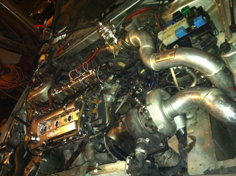 1993 Ford Probe - Custom engine bay modification a turbocharger and extensive piping. Text from watermark reads SUPERMOTORS.