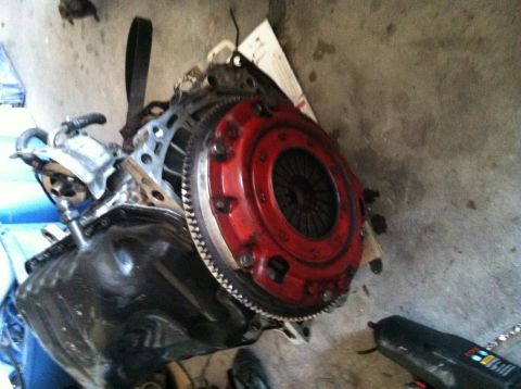 1993 Ford Probe - Engine component with a red clutch assembly and flywheel visible.