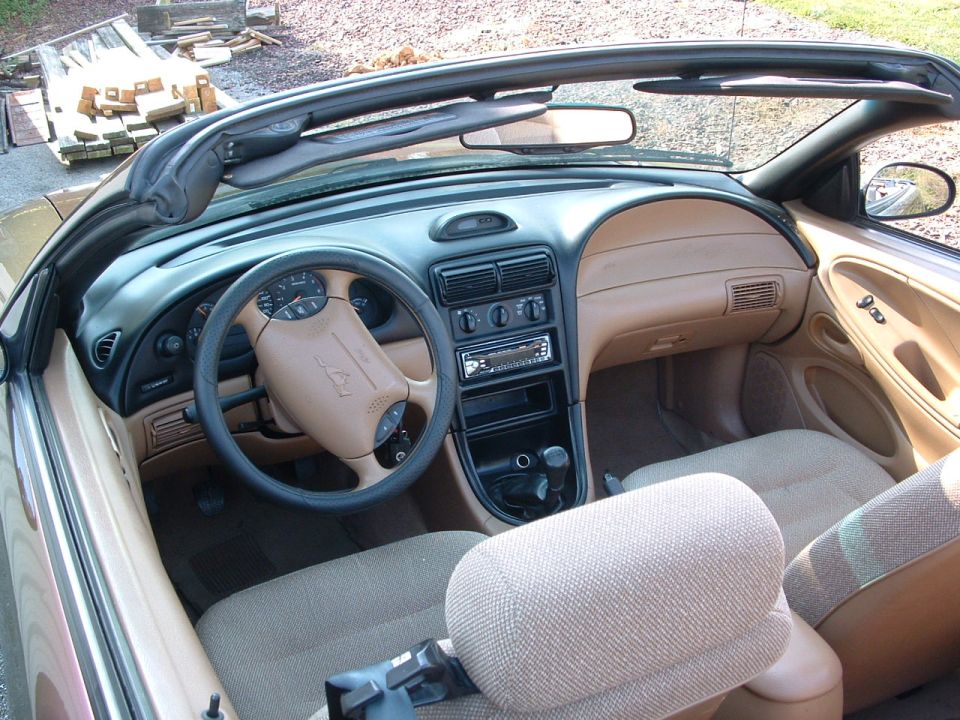 1997 Ford Mustang interior, tan dashboard and seats, convertible top up