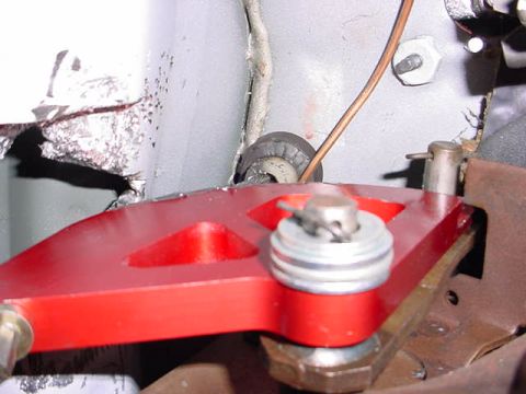 1991 Ford LTD Crown Victoria - Close-up view of a red aftermarket pedal assembly, showing mechanical components and hardware.