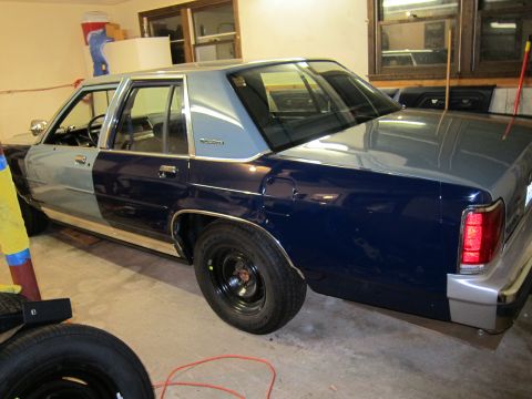 1991 Ford LTD Crown Victoria - This four-door sedan, possibly a Ford Crown Victoria, is seen in a garage with mismatched paint on its front and rear sections.