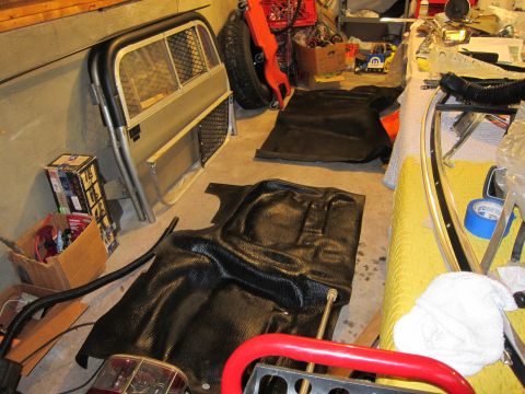 1991 Ford LTD Crown Victoria - Interior parts, including floor mats and a cargo partition, are stored on a garage floor.