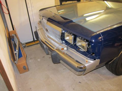 1991 Ford LTD Crown Victoria - The front of a two-tone blue and silver vehicle is shown, with its grille and headlights visible.