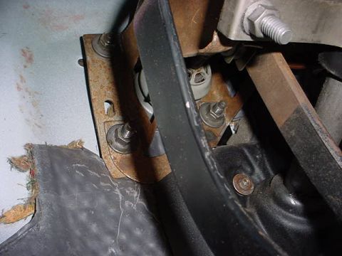 1991 Ford LTD Crown Victoria - Detail of a vehicle's interior pedal assembly, showing rusted metal components and worn plastic trim.