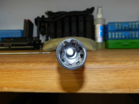 1996 Ford Bronco - A socket wrench is shown on a wooden table, with various tools and containers in the blurred background.