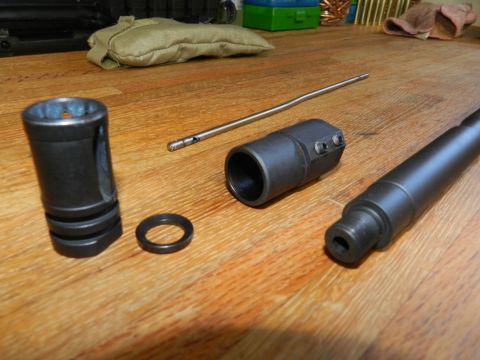 1996 Ford Bronco - Disassembled firearm components are laid out on a wooden surface.