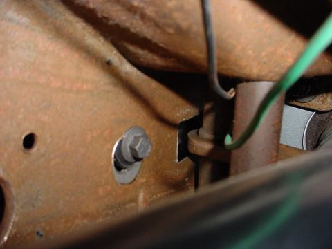 1991 Ford LTD Crown Victoria - A close-up view of a vehicle's undercarriage, showing rusted metal and electrical wiring.