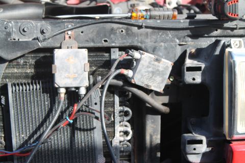 1990 Ford Bronco - Close-up view of electrical components and wiring in an engine bay.