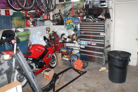 1990 Ford Bronco - A red sport motorcycle is visible in a garage filled with tools and storage items.