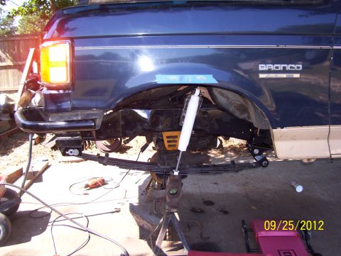 1990 Ford Bronco - Rear suspension of a Ford Bronco is visible, with a new shock absorber installed.