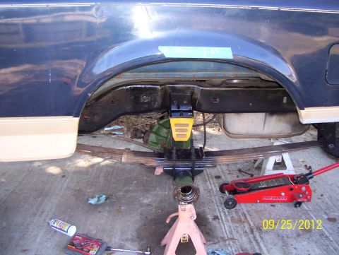 1990 Ford Bronco - Vehicle's rear axle and suspension components are visible during maintenance.