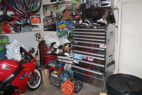 1990 Ford Bronco - A red sport motorcycle is visible in a garage filled with tools and equipment.