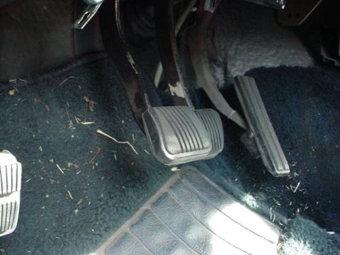 1991 Ford LTD Crown Victoria - Close-up of the brake and accelerator pedals in a vehicle's footwell.